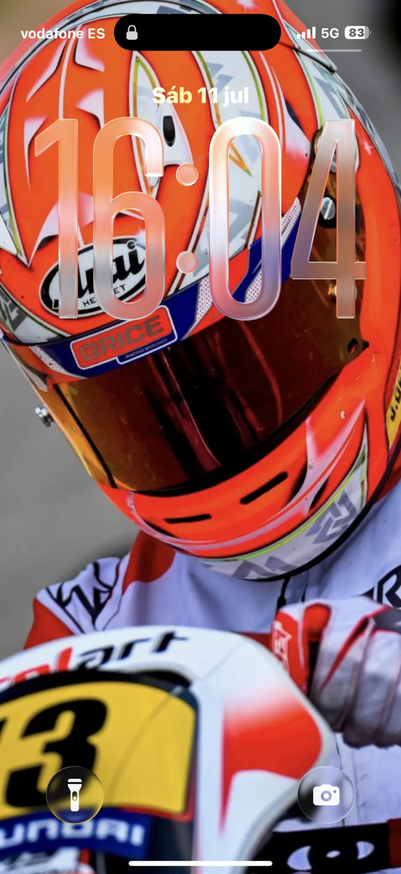 Karting driver in racing suit and orange helmet